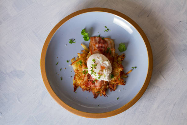istock Potato cakes with  bacon and poached egg, garnished with spring onion and parsley. Vegetable fritters, pancakes 1207518901