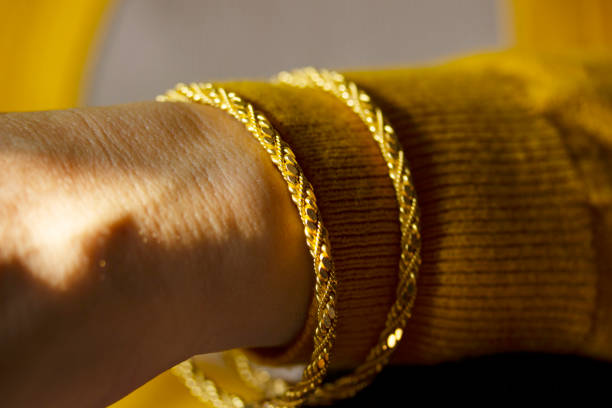 istock young woman wearing gold bracelet 1207520915