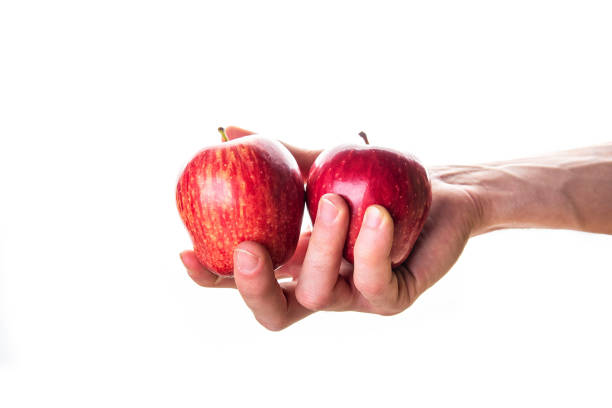 istock Anonymous person showing red ripe apples to camera 1207524275