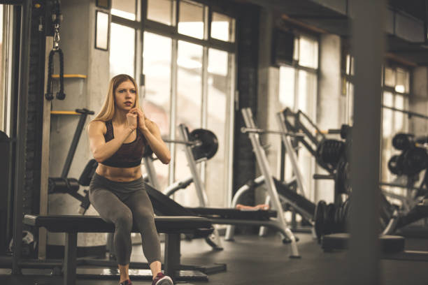 istock Woman doing a single-leg squat with the help of a bench 1207528447