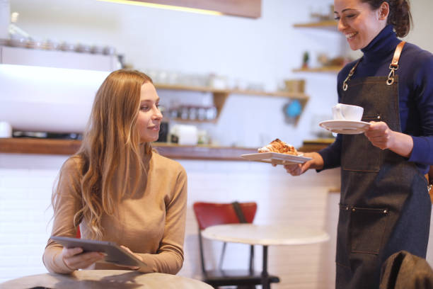 istock Barista serving a coffee to a costumer. 1207528492