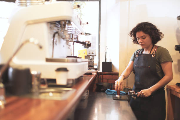 istock One hipster barista preparing coffee in an espresso machine. 1207528496
