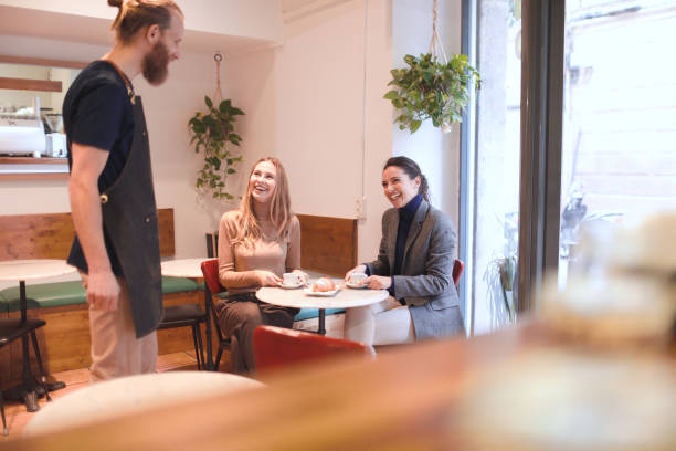 istock Barista with costumers in a coffee shop. 1207528517
