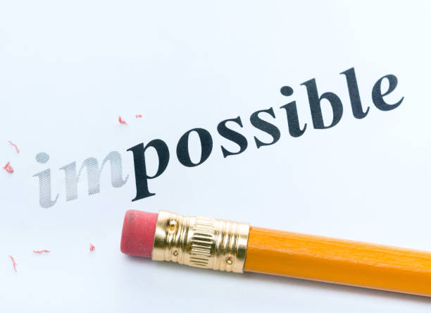Word ' impossible ' and pencil with eraser close-up Word and pencil with eraser close-up Increased focus area impossible possible stock pictures, royalty-free photos & images