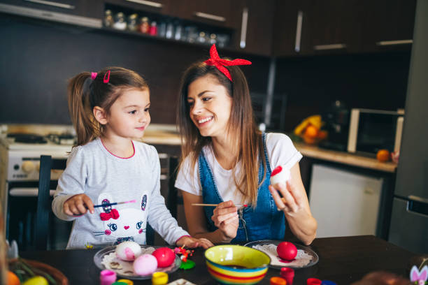 istock Happy Family Paintings Easter Eggs. 1207532465