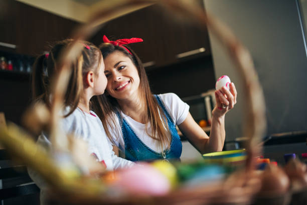istock Happy Family Paintings Easter Eggs. 1207532469