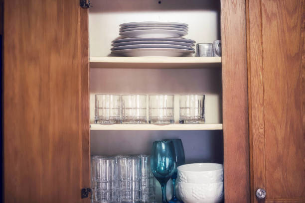 istock A kitchen cabinet full of plates and drinking glasses 1207534949