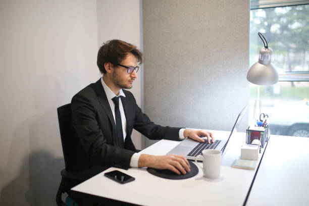istock Shot of a young businessman using a laptop at work 1207538323