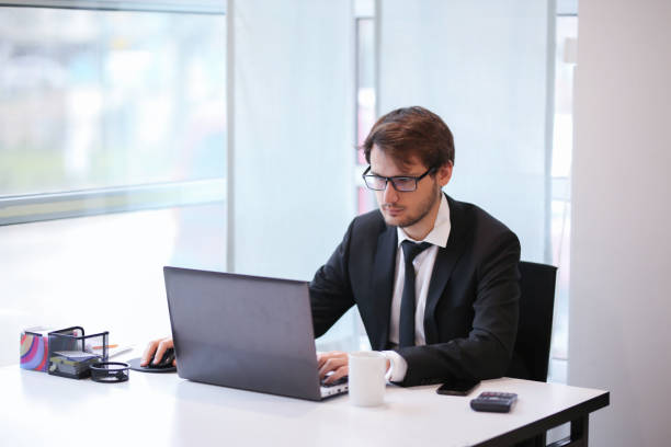 istock Serious businessman looking at laptop screen. 1207539111