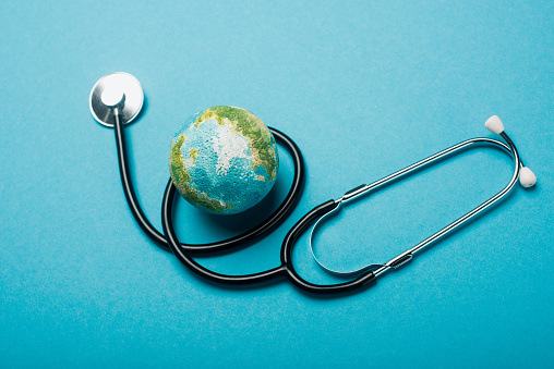 Globo y estetoscopio sobre fondo azul, concepto del día mundial de la salud photo
