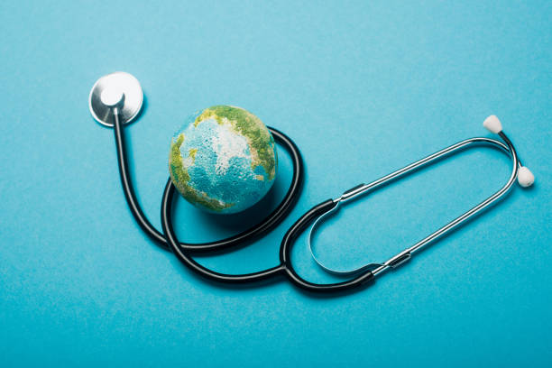 istock Globe and stethoscope on blue background, world health day concept 1207539379