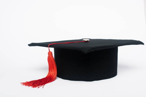 istock Black graduation cap with red tassel on white background 1207539416