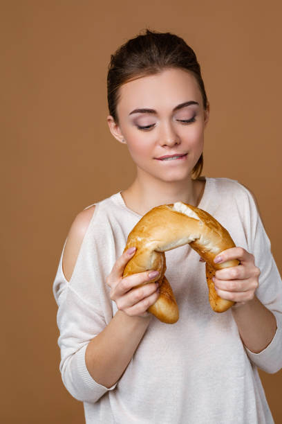 istock young woman holding bread 1207540215