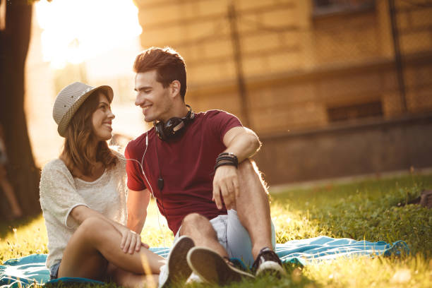 istock Enjoying music and sitting on the grass during sunset 1207541146