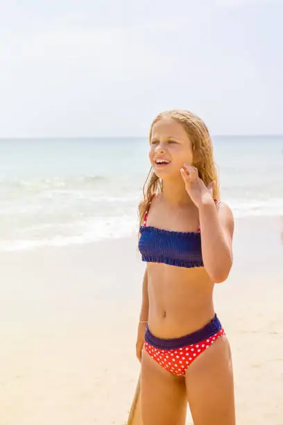 9 year’s old blonde hair girl at the beach