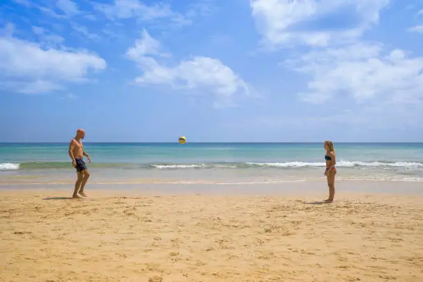 Father and daughter playing football at the beach in Porto Santo’s island