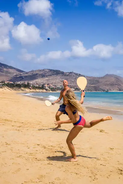 Father and daughter playing racketball at Porto Santo beach