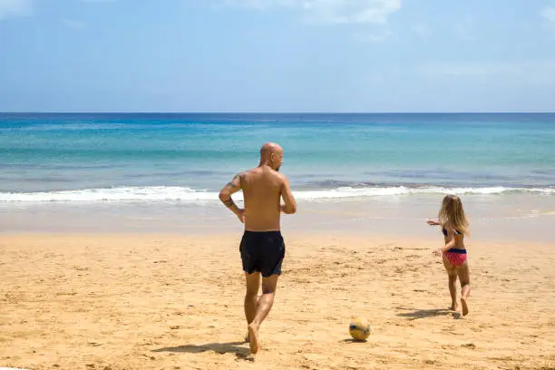 Father and daughter playing soccer at the beach in Porto Santo’s island