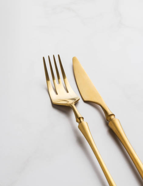 istock golden fork and knife on a white background. 1207541283