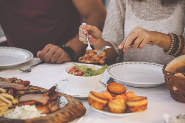 istock Dinning table and female hands taking food 1207542280