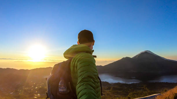 istock Bangli - A man enjoying sunrise on Mt Batur 1207544374