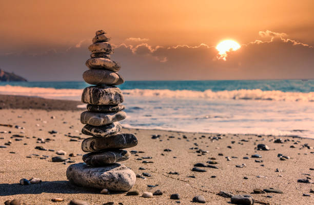 istock Meditative Stone Stack on a Mediterranean Beach in Southern Italy at Sunset 1207544376