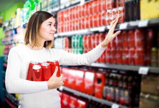 istock Woman choosing cold beer in supermarket 1207544468