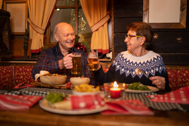 istock senior couplw eating out in alpine mountain restaurant 1207544626