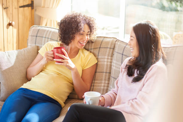 istock pregnant woman laughing with friend 1207547520