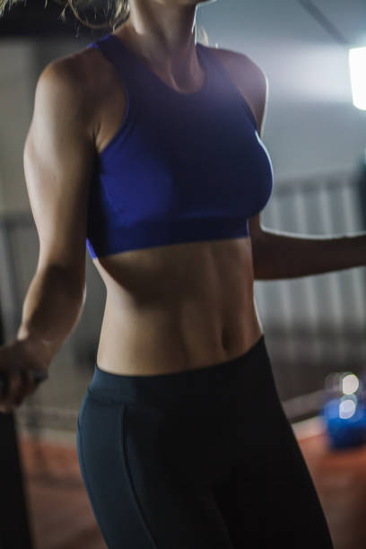 istock Woman training cardio and skipping on a jump rope 1207548824