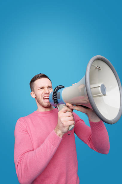 istock Speaking announcement into megaphone 1207549386