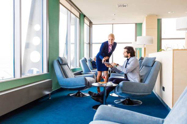 airport client service manager talking with businessman in vip lounge - airport waiting room waiting airport lounge imagens e fotografias de stock