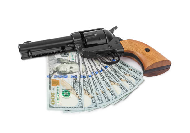 istock Gun and money 1207553983