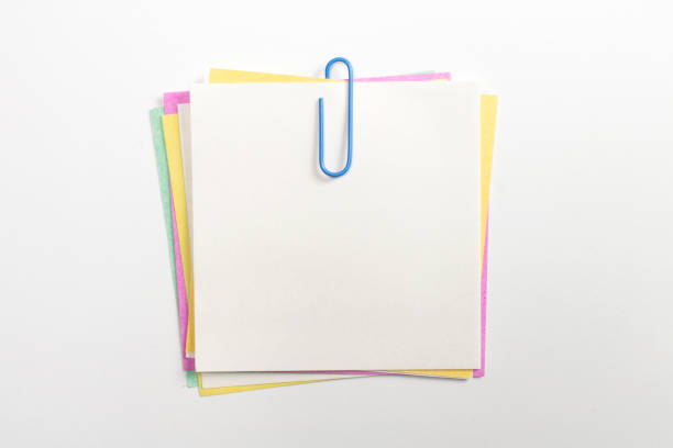 istock Colorful note paper pin with blue paper clips and isolated on white. 1207555520