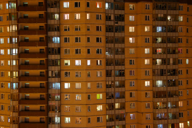 istock Apartment house windows at night 1207555674