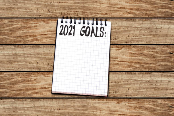 istock 2021 goals text on notebook on wood table. Business motivation, inspiration concept. 1207558487