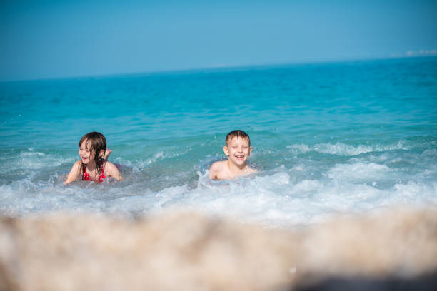 istock Two kids are playing on the beach 1207560710