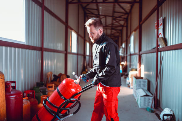 istock Male Worker Checking Gas Cylinder Compression Valve In Storage 1207562197