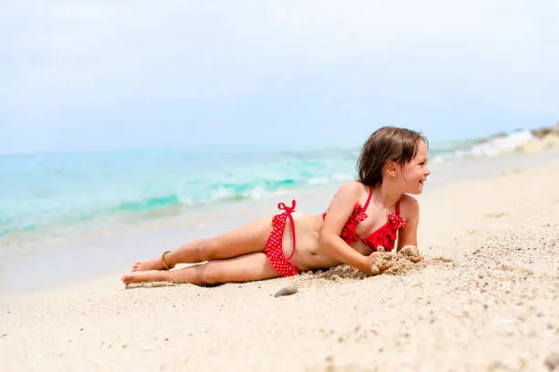 Photo of Little girl enjoying by the water