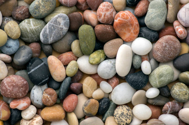 istock Small colorful pebbles background, simplicity, daylight, stones 1207564341