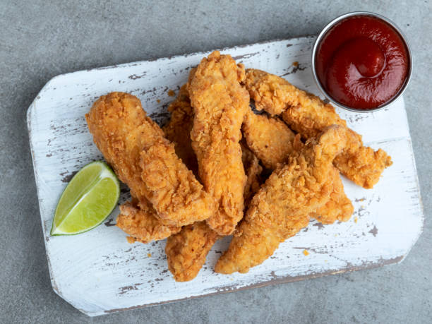 istock crispy fried breaded chicken breast strips and sauce 1207566780