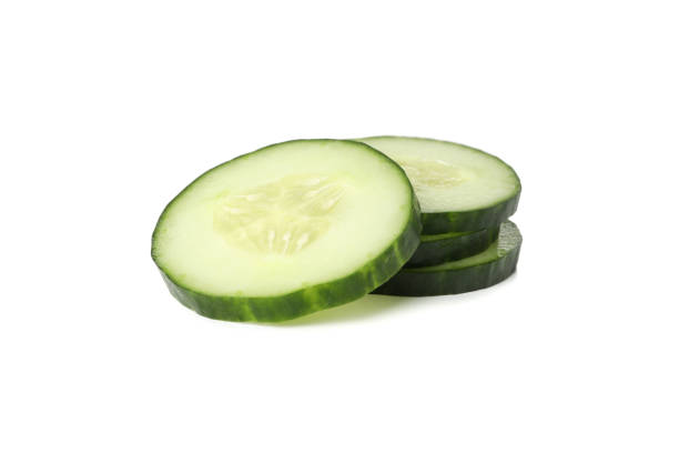 istock Fresh cucumber slices isolated on white background 1207573101