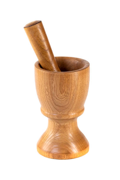 istock Wooden mortar (pounder) and pestle isolated on white 1207573396