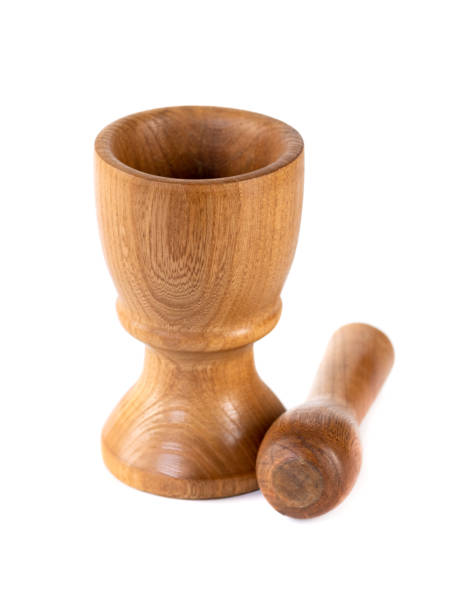 istock Wooden mortar (pounder) and pestle isolated on white 1207573816
