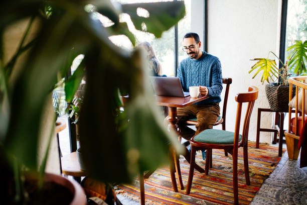 istock Young man sitting in a cafe 1207574977