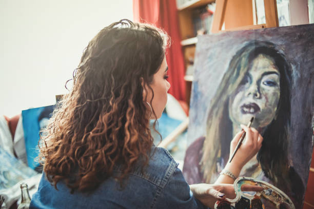 istock Creative young artist painting at home 1207576730