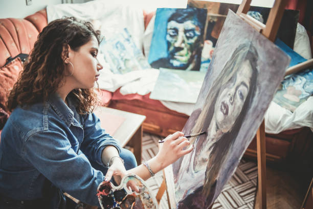 istock Creative young artist painting at home 1207576903