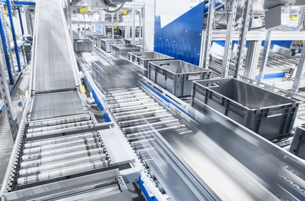 Modern conveyor system with boxes in motion. stock photo