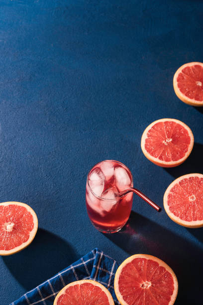 istock Organic grapefruit slices and cold drink. Glass of grapefruit lemonade 1207577453