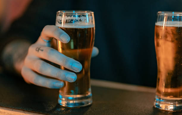 istock Person holding a beer glass 1207577503